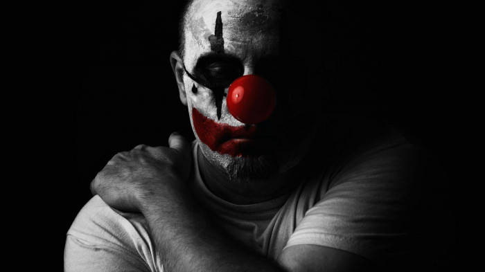 Sad Joker Clown Holding His Shoulder Wallpaper