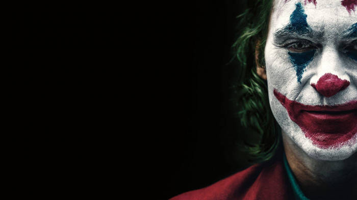 Download Sad Joker Half Face With Black Background Wallpaper | Wallpapers .com
