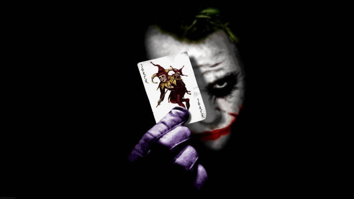 Sad Joker Holding A Playing Card Wallpaper