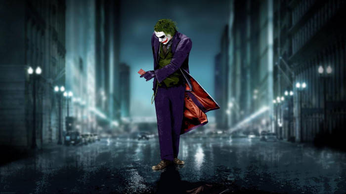 Sad Joker Walking With A Card Wallpaper
