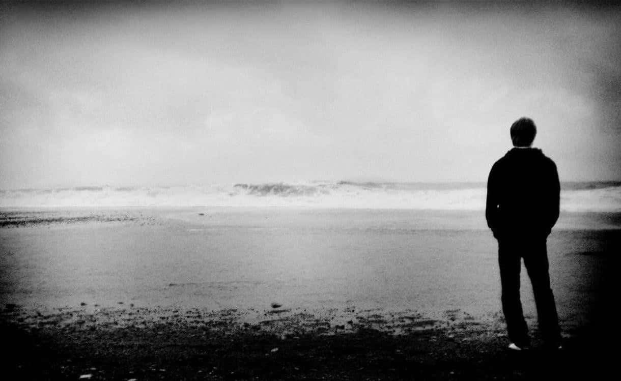 Sad Person Silhouette On Beach Greyscale Picture