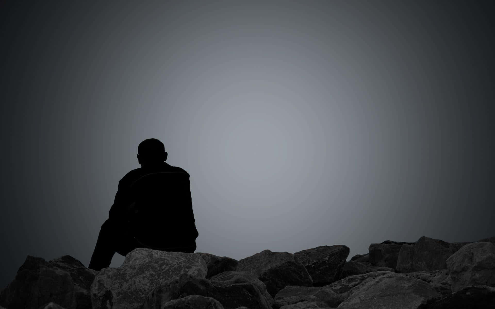 Sad Person Sitting On Rock Picture