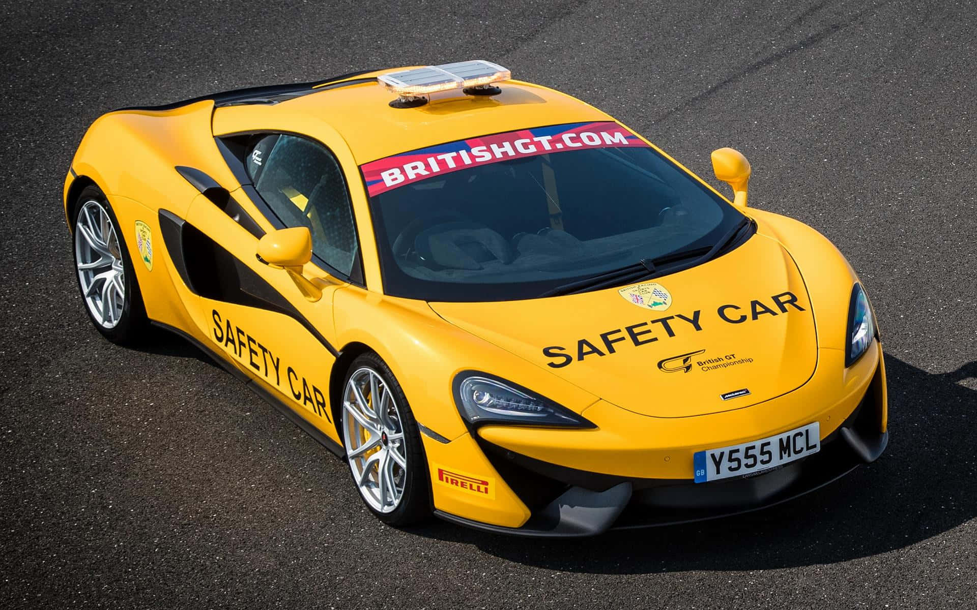 A sleek silver safety car on the racetrack Wallpaper