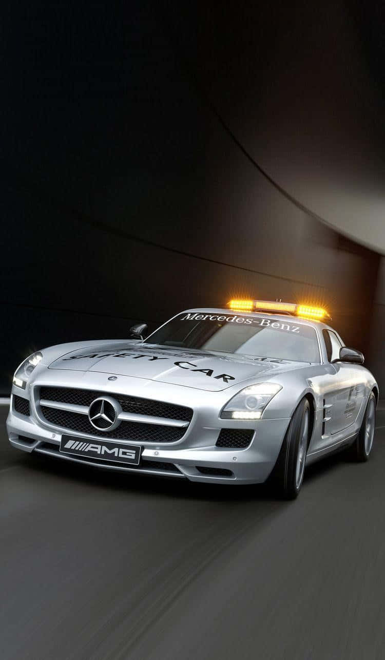 A modern yellow safety car actively guiding the racecars during a high-speed race Wallpaper