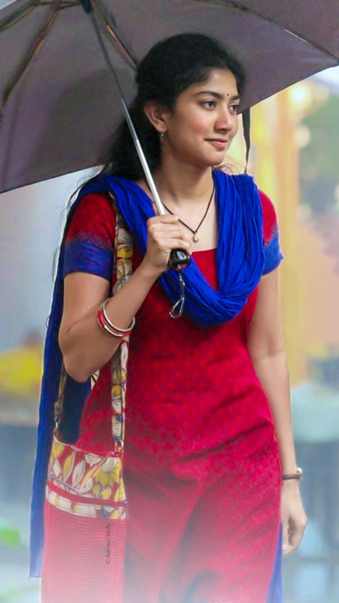 Sai Pallavi Holding Up An Umbrella Background