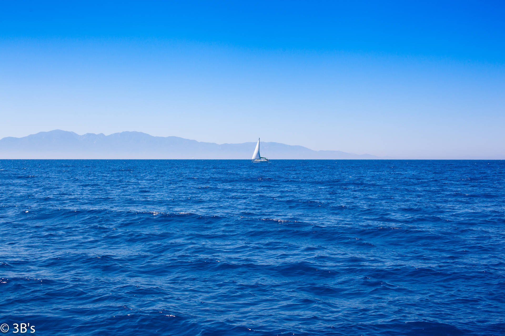 Sailing Boat On Blue Waters Wallpaper
