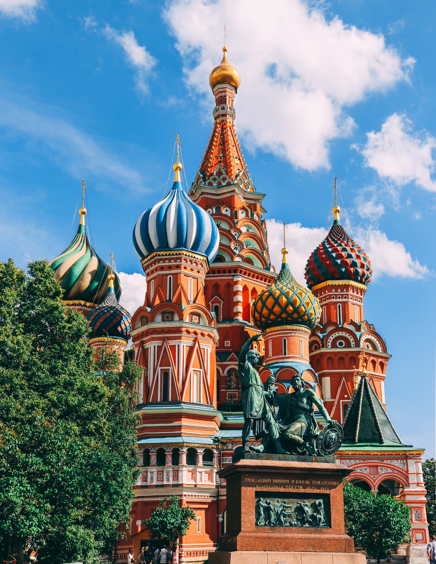 Majestic view of Saint Basil's Cathedral amidst lush greenery Wallpaper