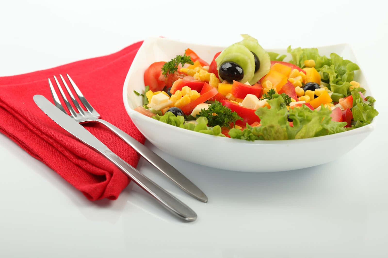 A vibrant and healthy salad bowl with a variety of greens and vegetables.