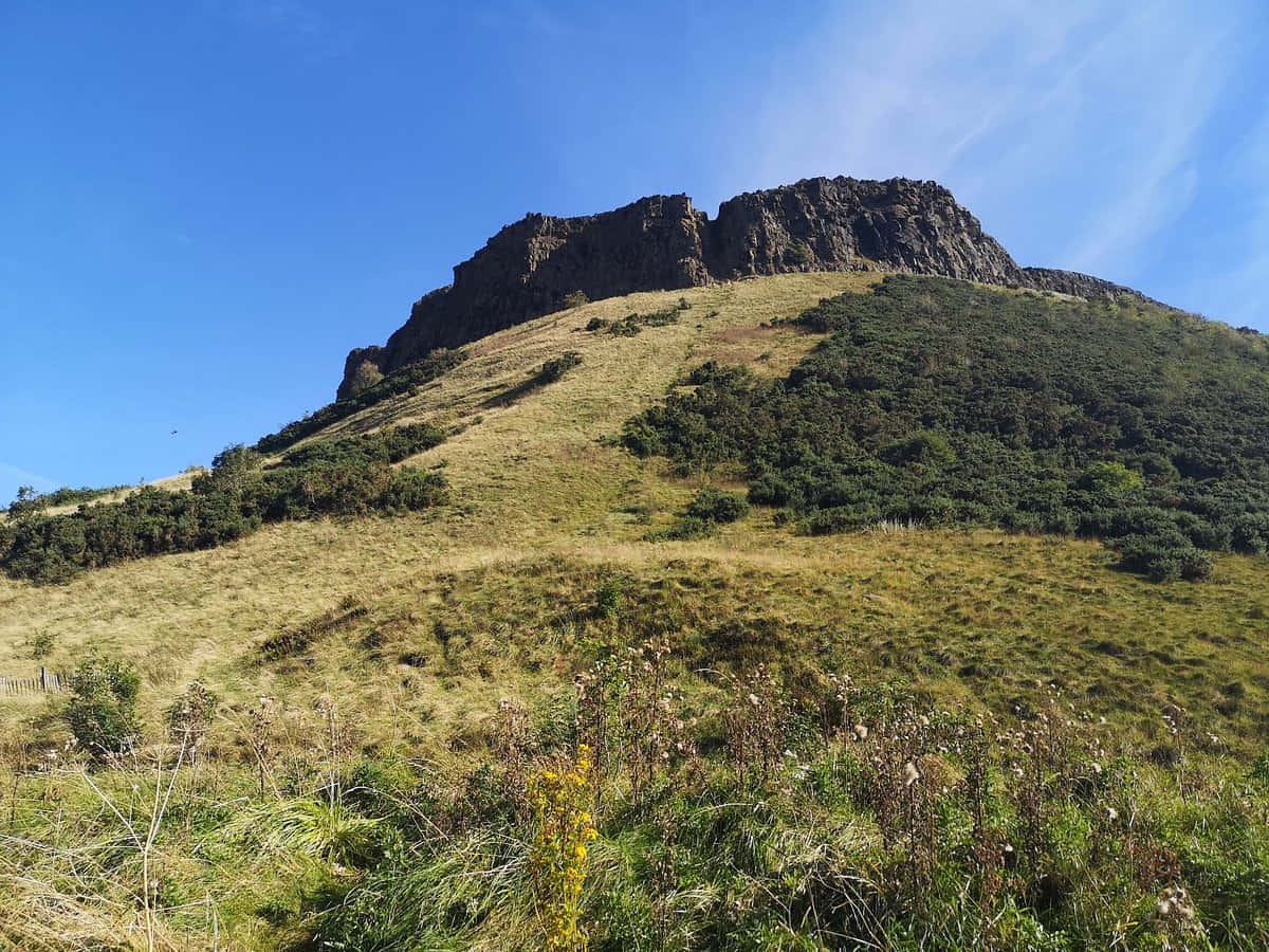 Download Salisbury_ Crags_ Sunny_ Day Wallpaper | Wallpapers.com