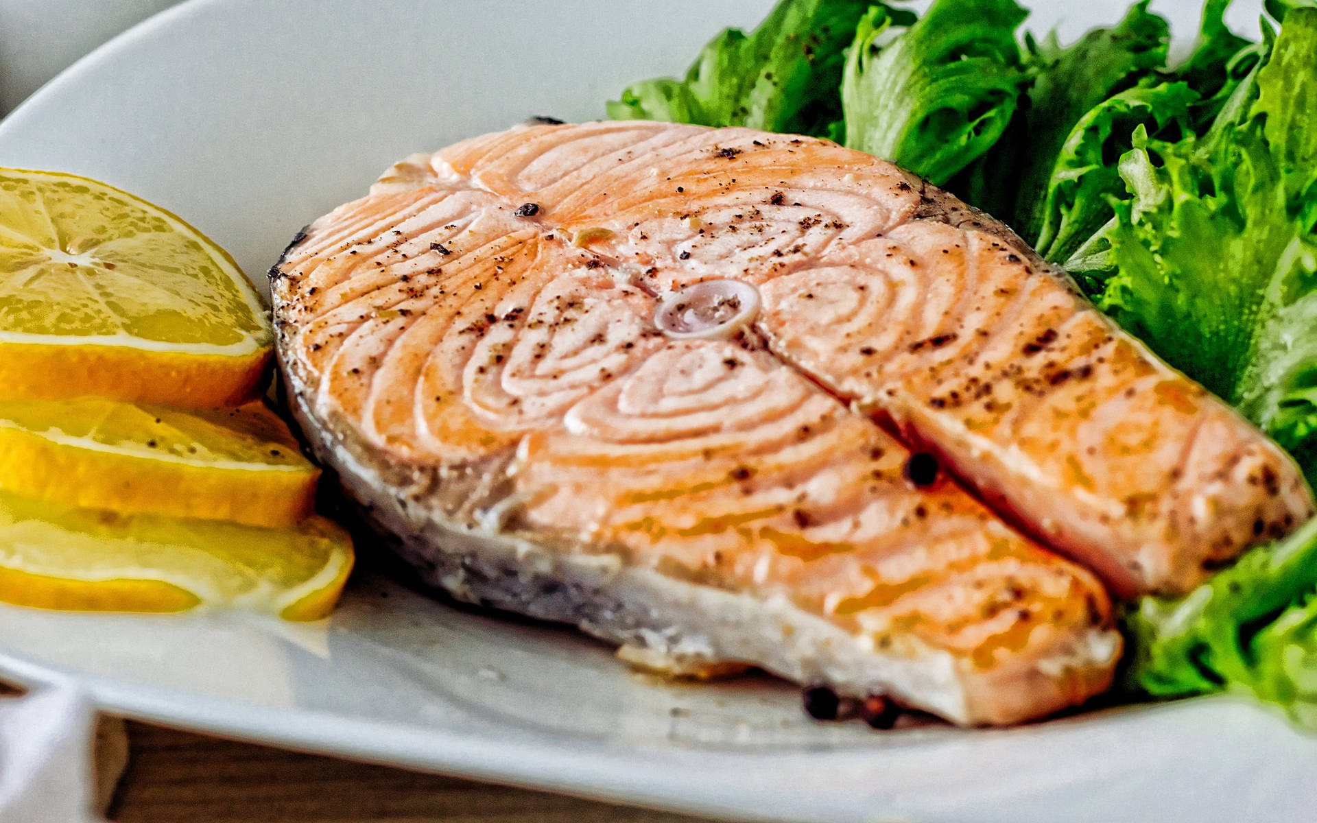 Salmon Steak With Greens And Lemon Slices Wallpaper