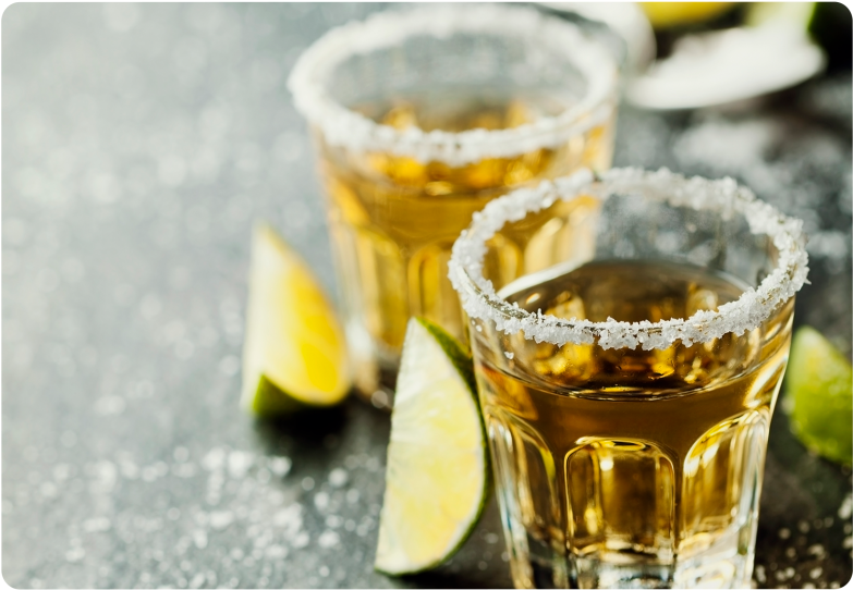 Salt Rimmed Tequila Shots With Lime Wedges PNG
