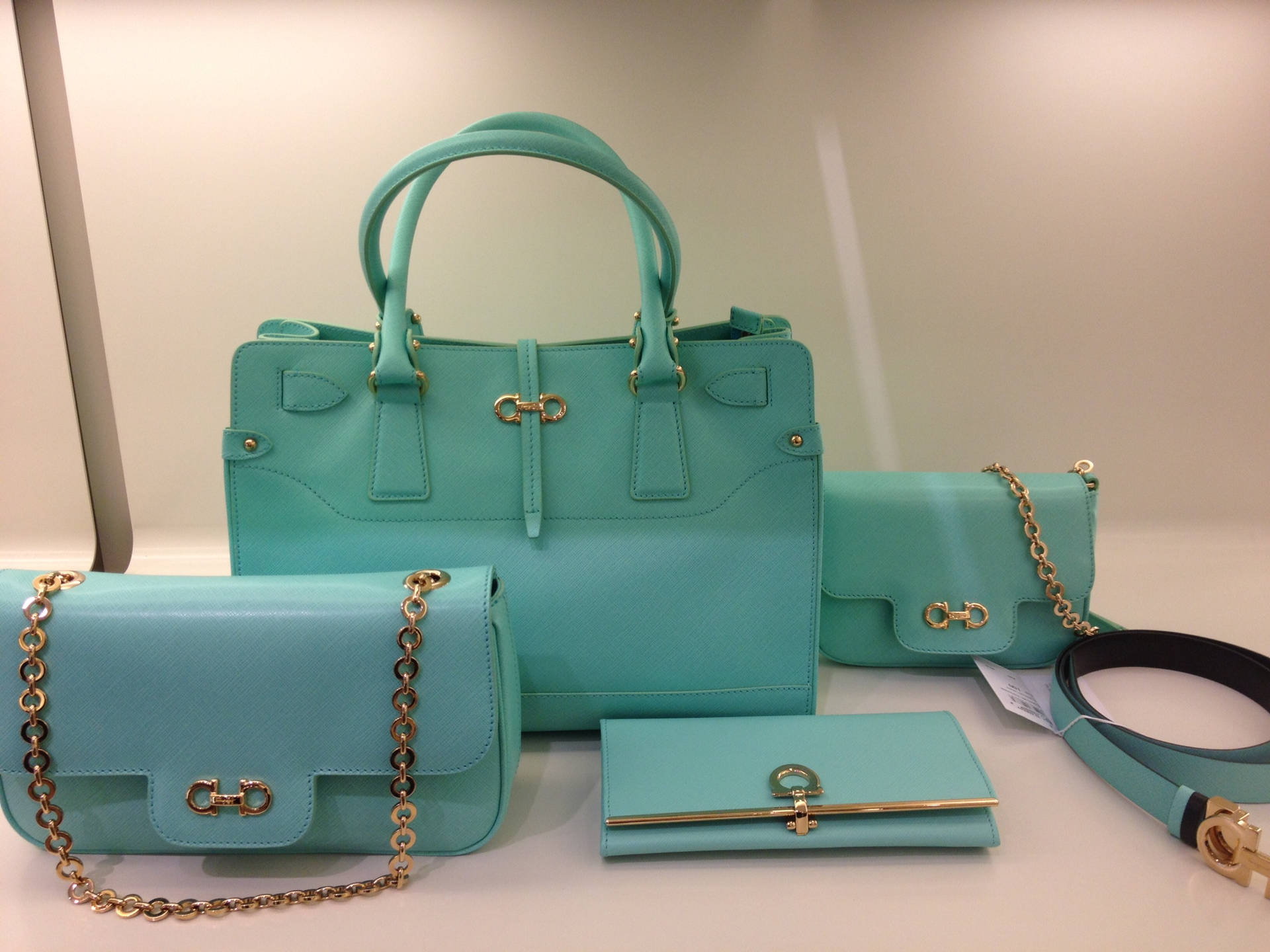 Salvatore Ferragamo Turquoise Bag Set showcasing elegance and luxury Wallpaper