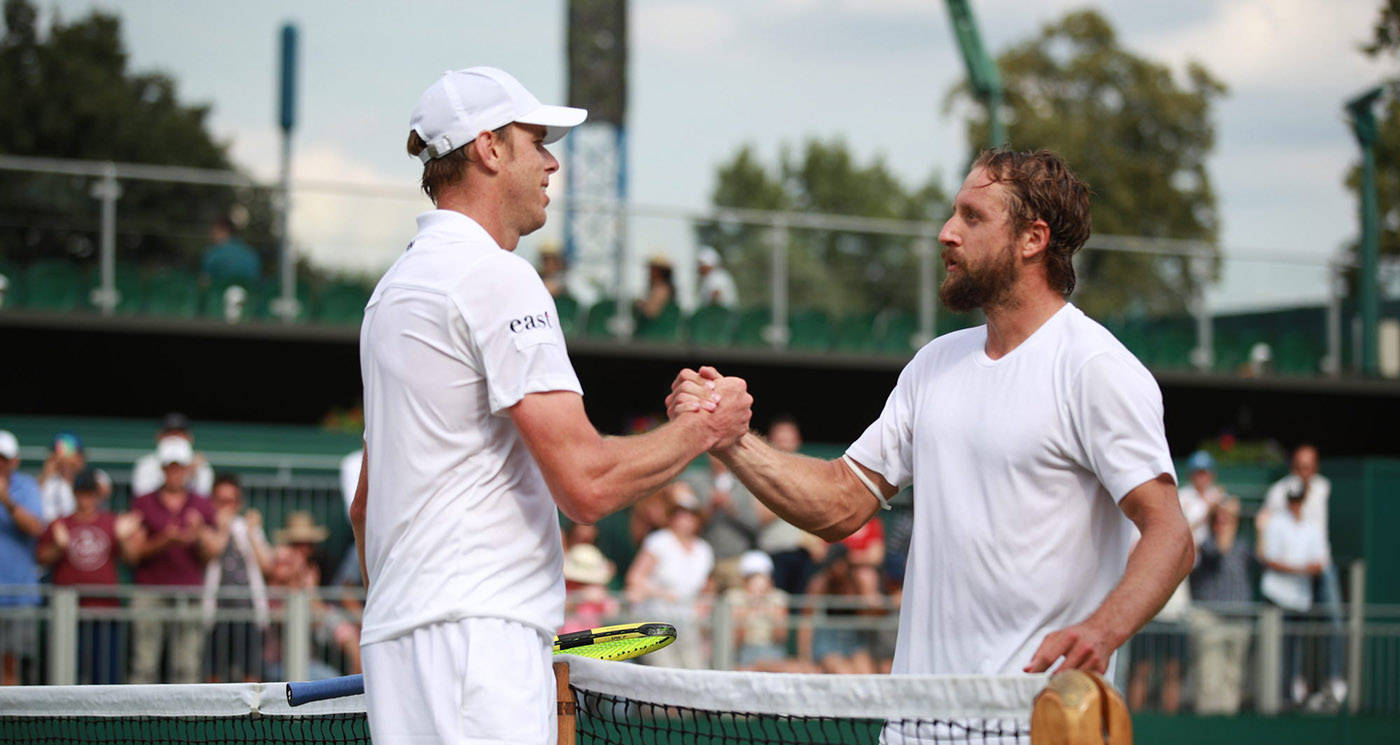 Sam Querrey offering a handshake post-match on the tennis court Wallpaper