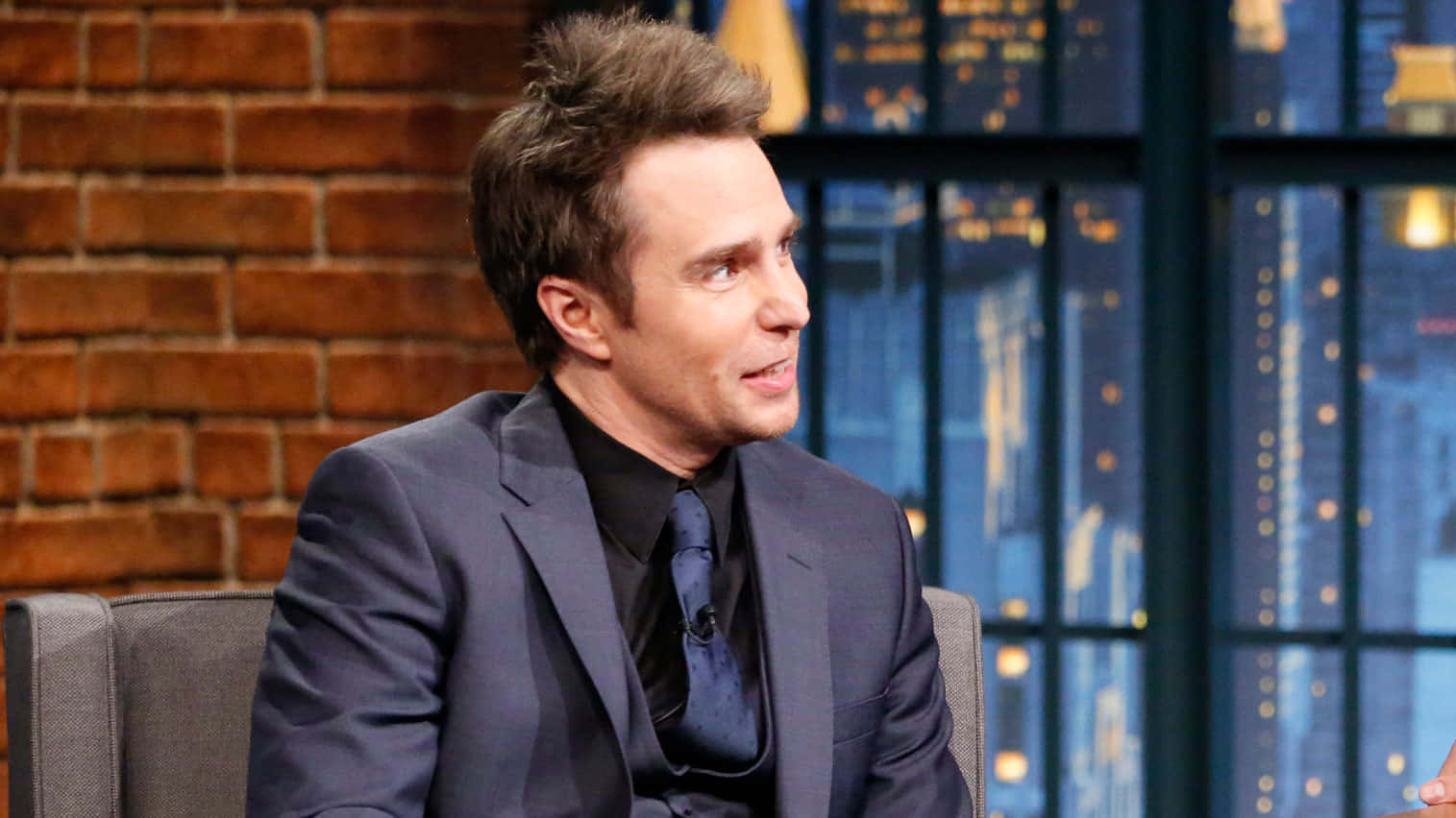 Charismatic Sam Rockwell On Late Night With Seth Meyers Wallpaper