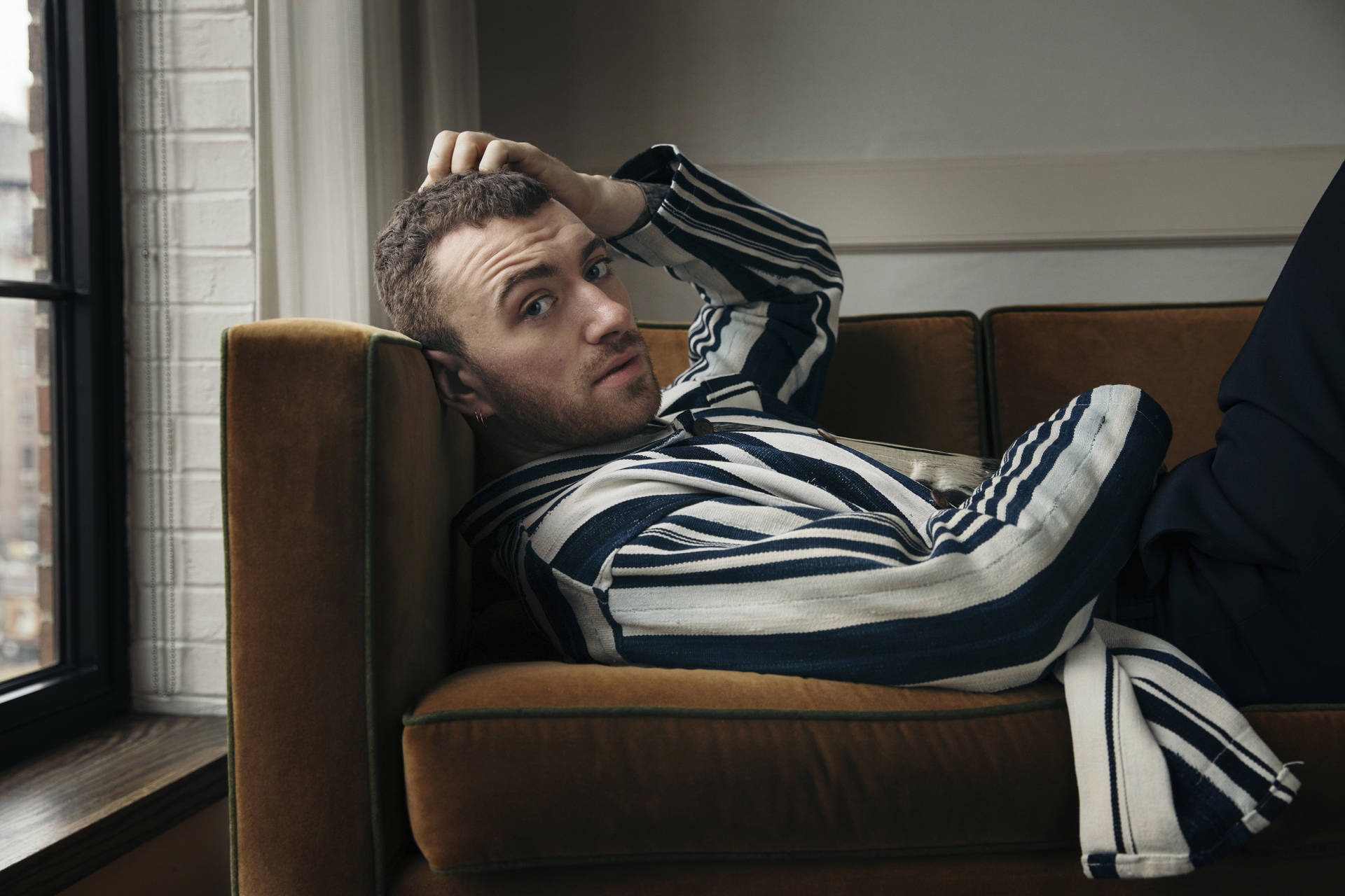 Sam Smith Cozy On Couch Background