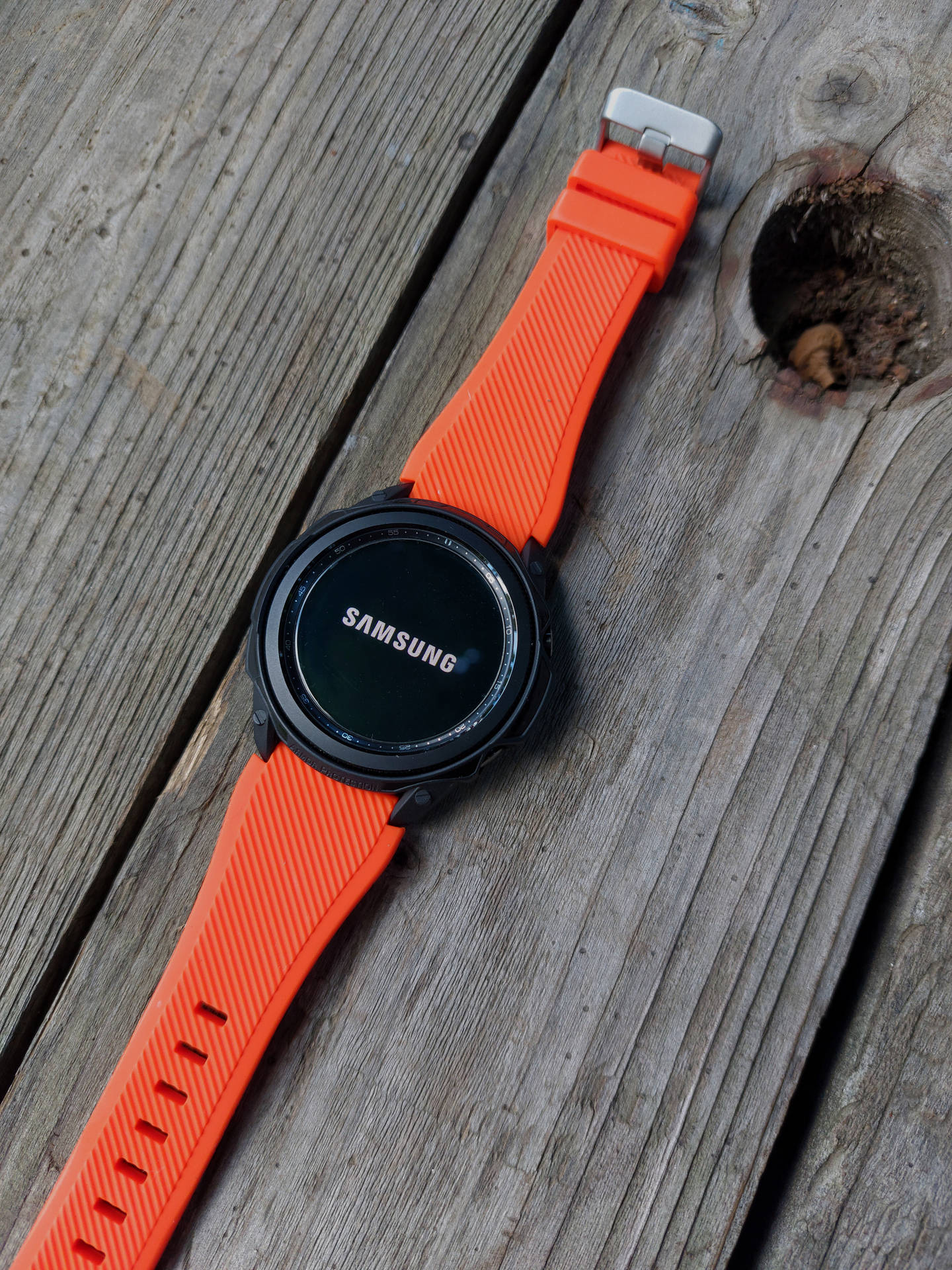 Samsung Smartwatch With Orange Band Wallpaper