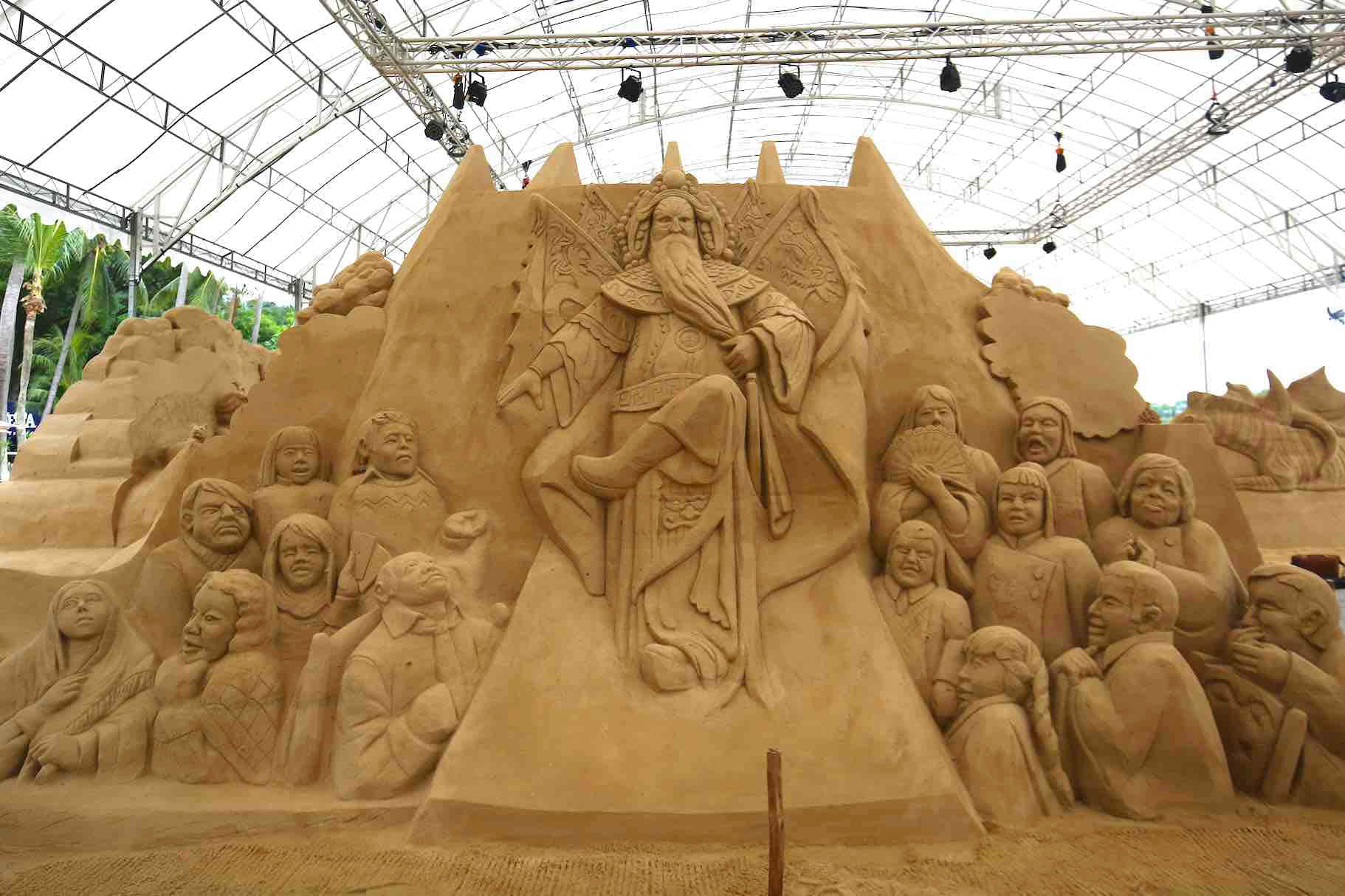 A Large Sand Sculpture With People On It