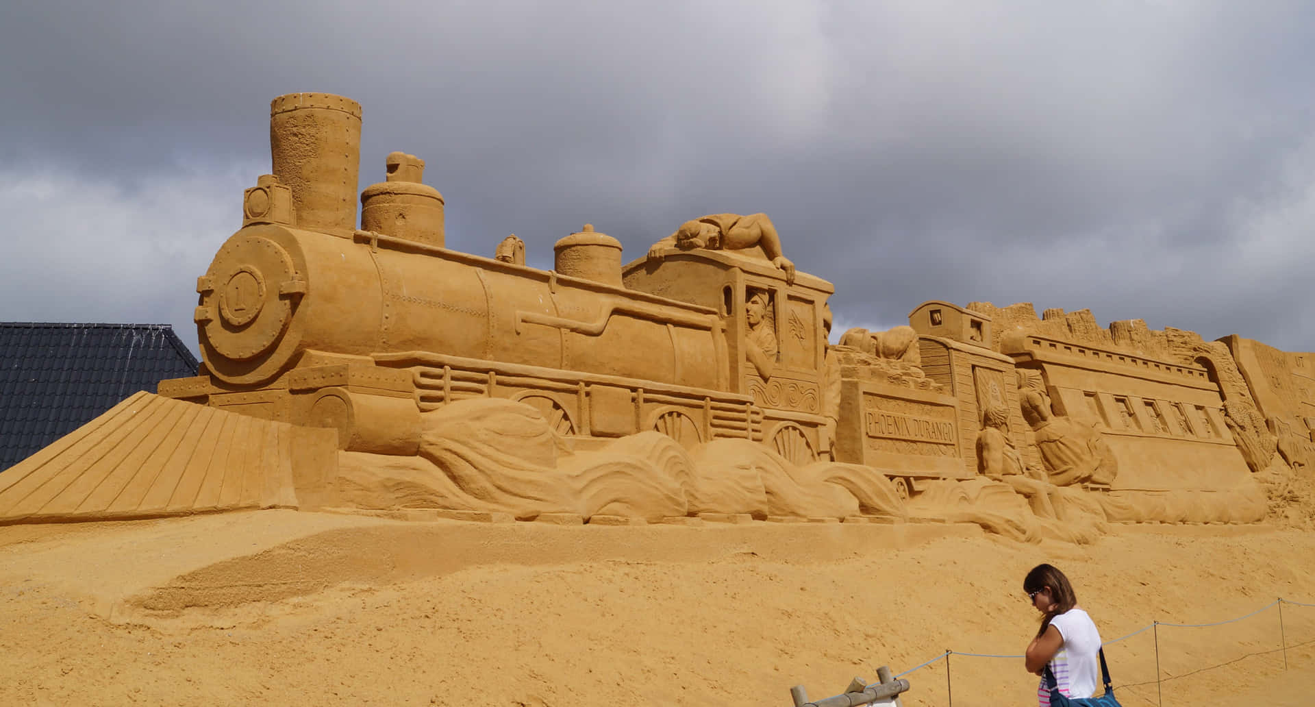 A Woman Is Standing Next To A Sand Train