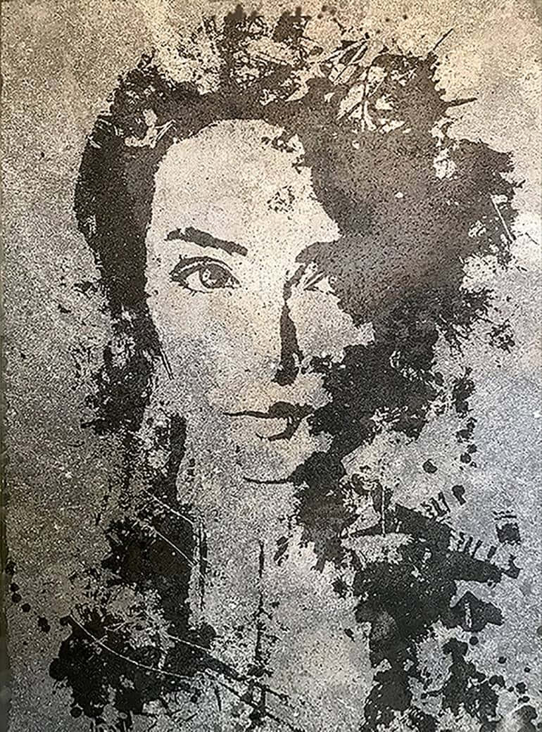 A Painting Of A Woman's Face On A Wall