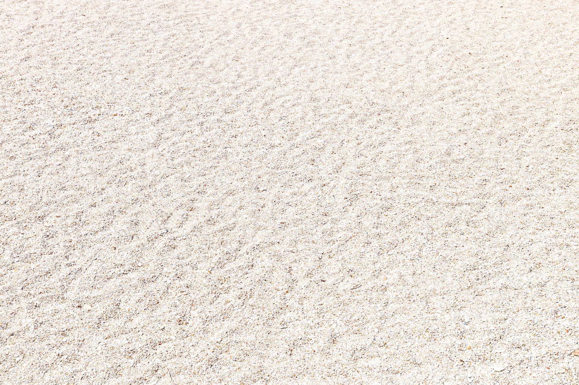 A beautiful view of white sand beneath a clear, blue sky