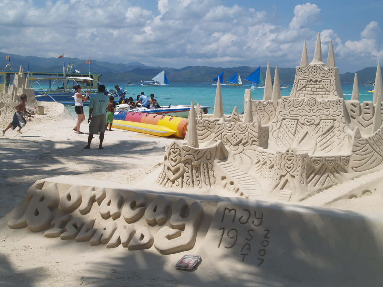 Majestic sandcastle standing tall on a beautiful beach Wallpaper