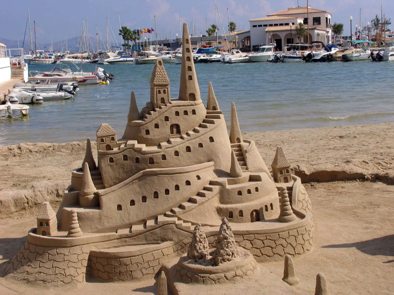 Majestic Sandcastles Stands Tall on Serene Beach Wallpaper
