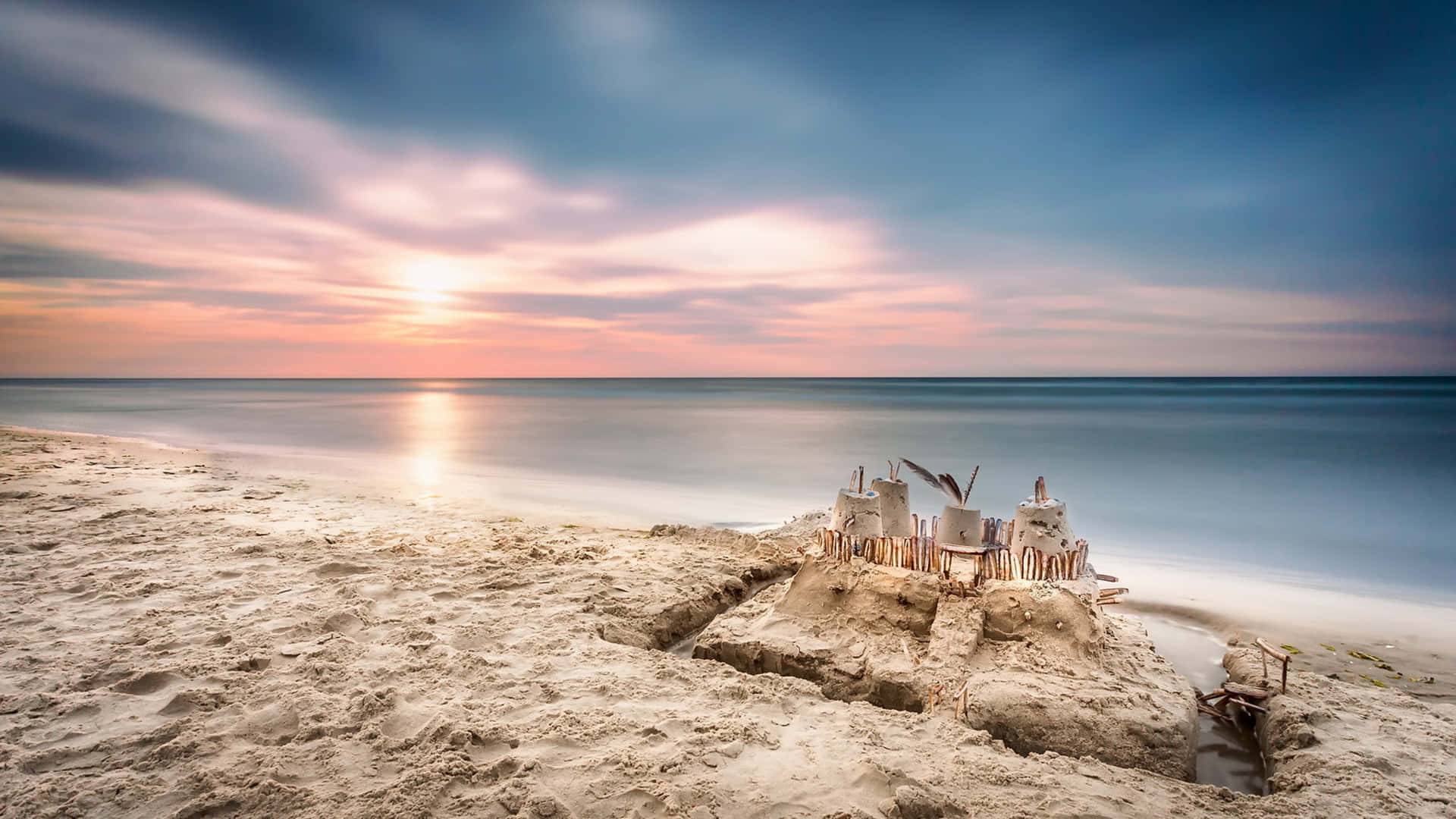 Enchanting Sandcastle Masterpiece on a Serene Beach Wallpaper