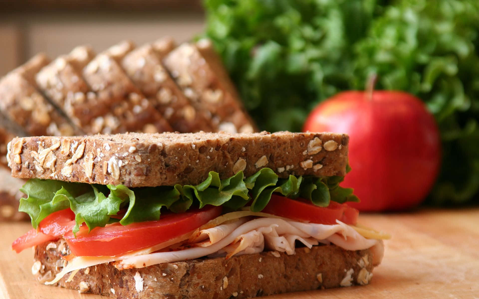 A Sandwich With Lettuce, Tomatoes, And Turkey