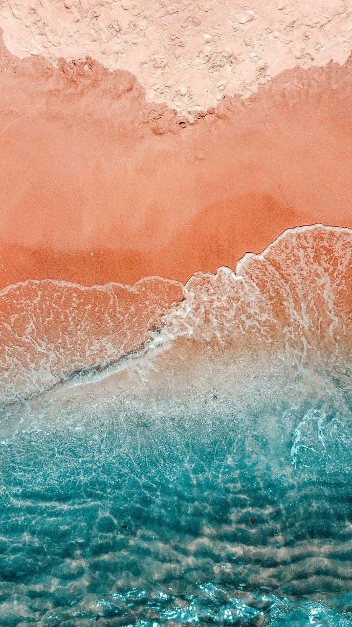 Sandy Shorelineand Turquoise Waves Wallpaper