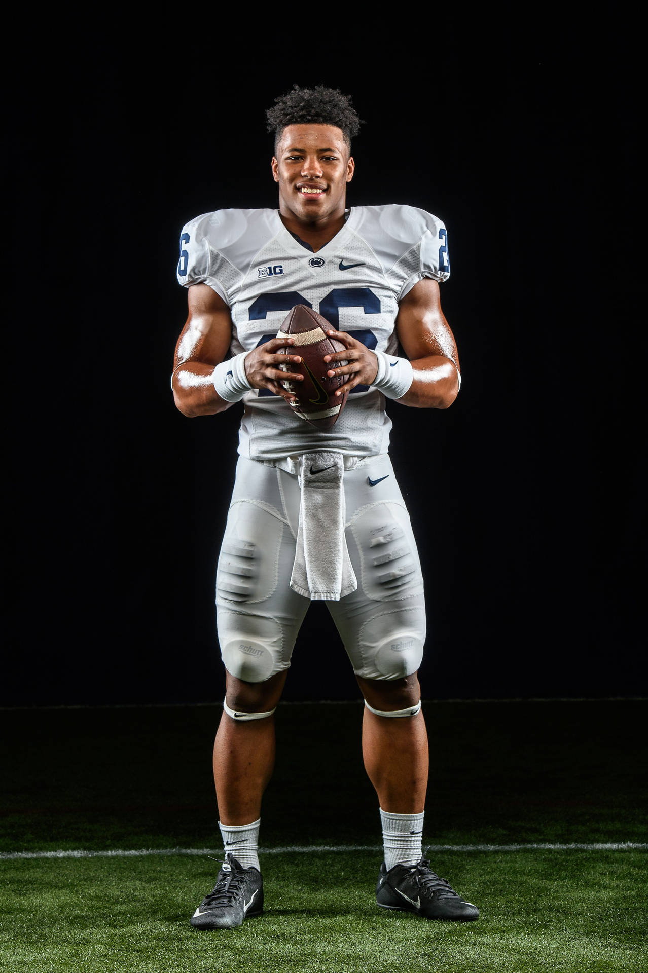 Download Saquon Barkley in action on the field Wallpaper