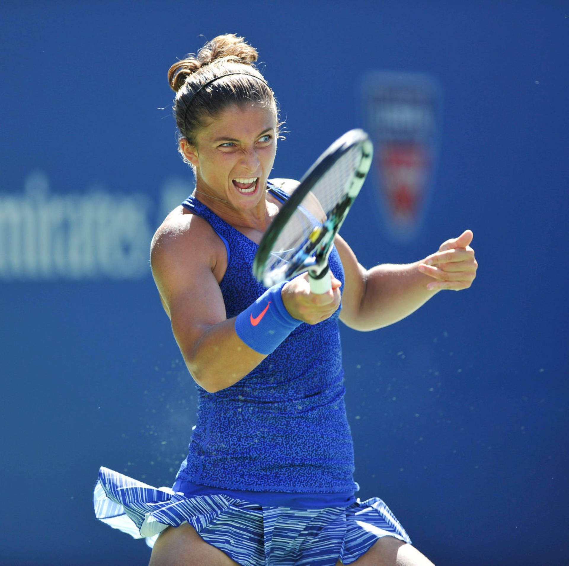 Italian professional tennis player Sara Errani showcasing a committed expression during a match. Wallpaper