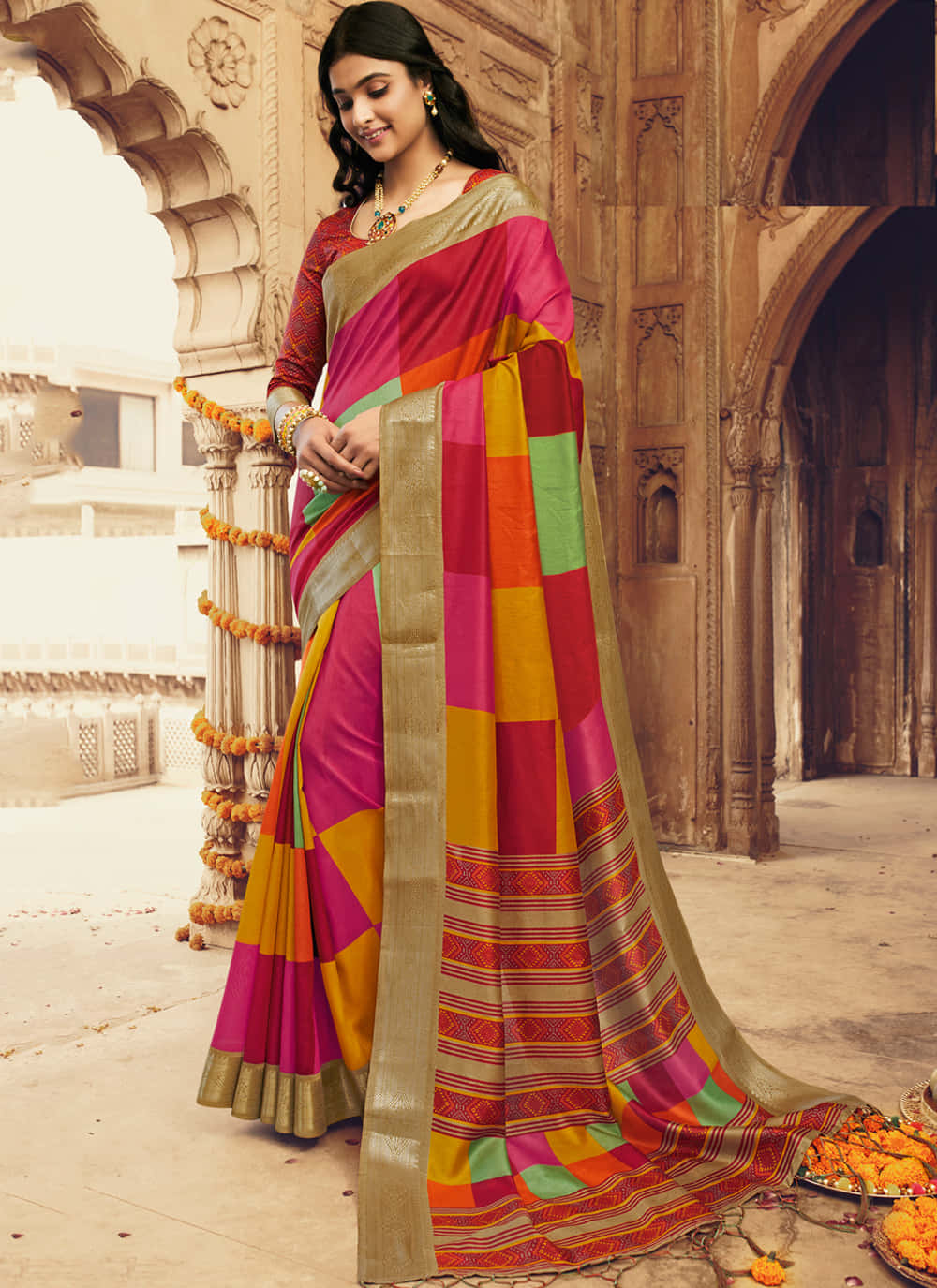 A woman looks beautiful in a striking blue saree.