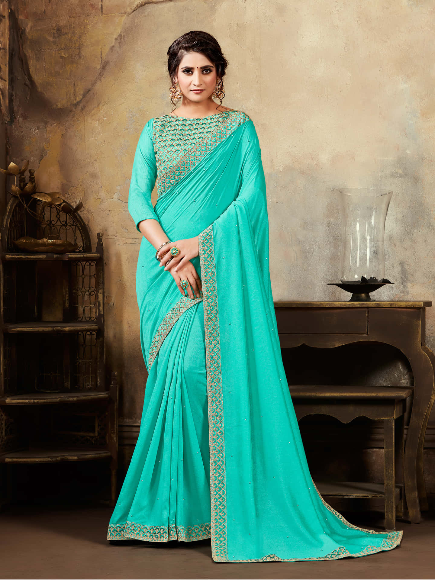 A Beautiful Turquoise Colored Saree With Embroidered Border