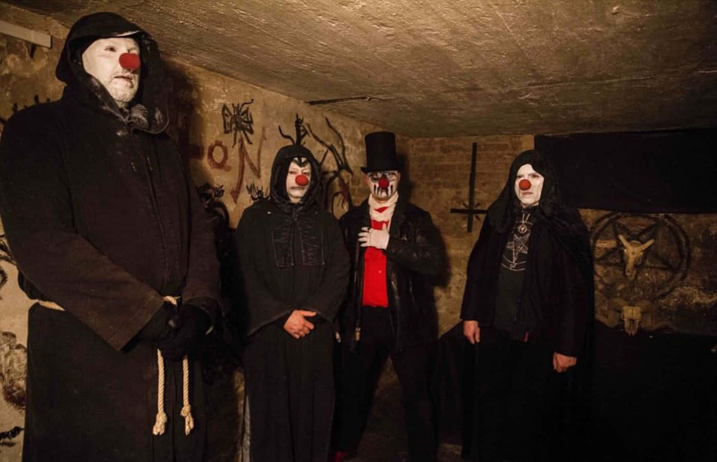 A Group Of Clowns Standing In A Dark Room