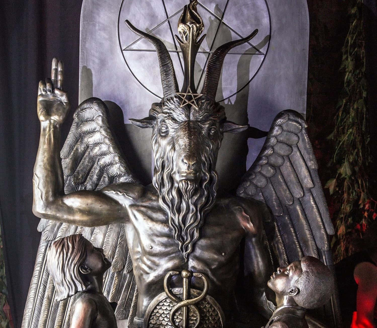 A demonic figure in suit, cloak and horns to showcase the dark undertone of Satanic