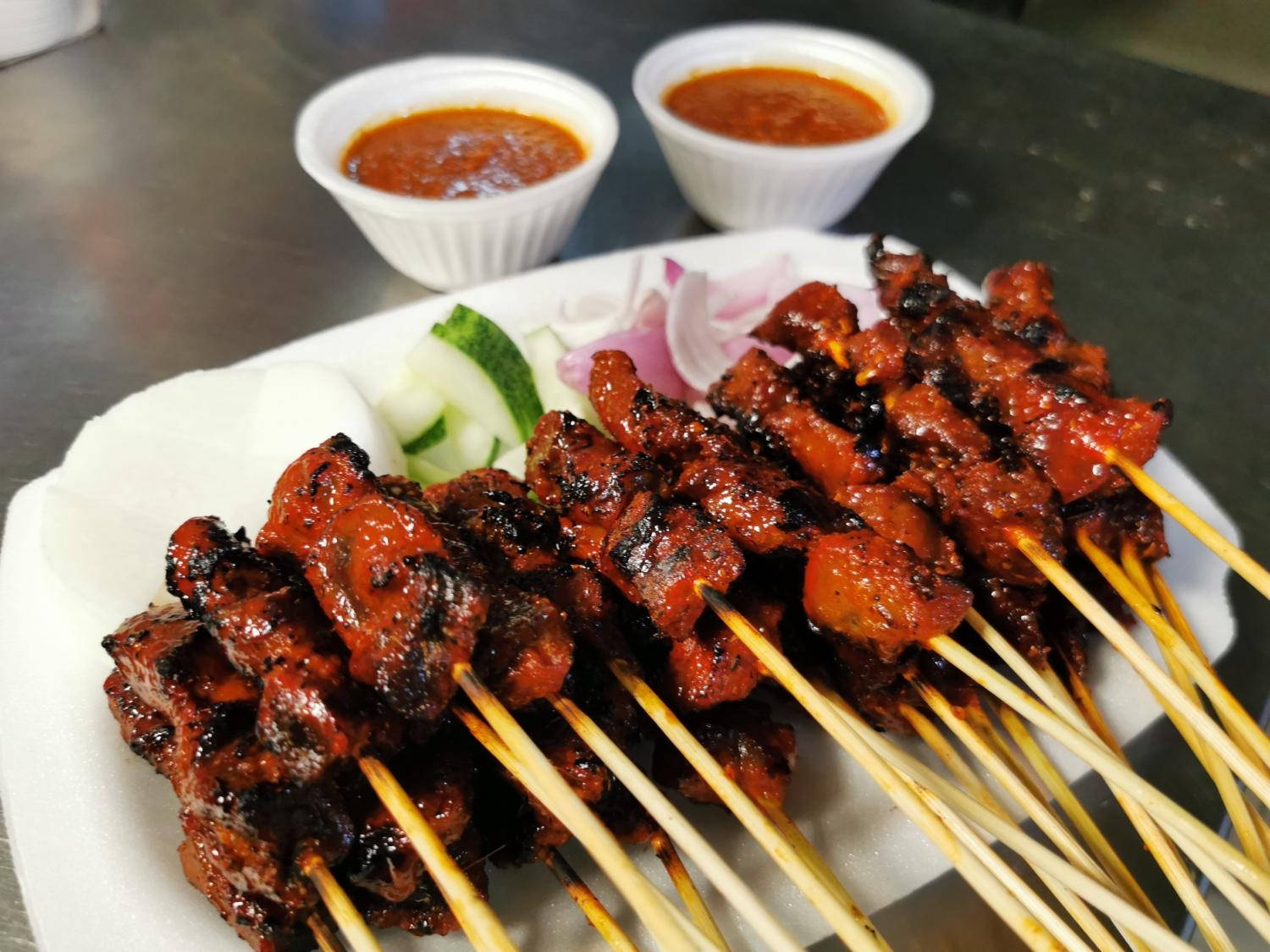 "Delicious Satay Selection with Refreshing Cucumber Salad on the Side" Wallpaper