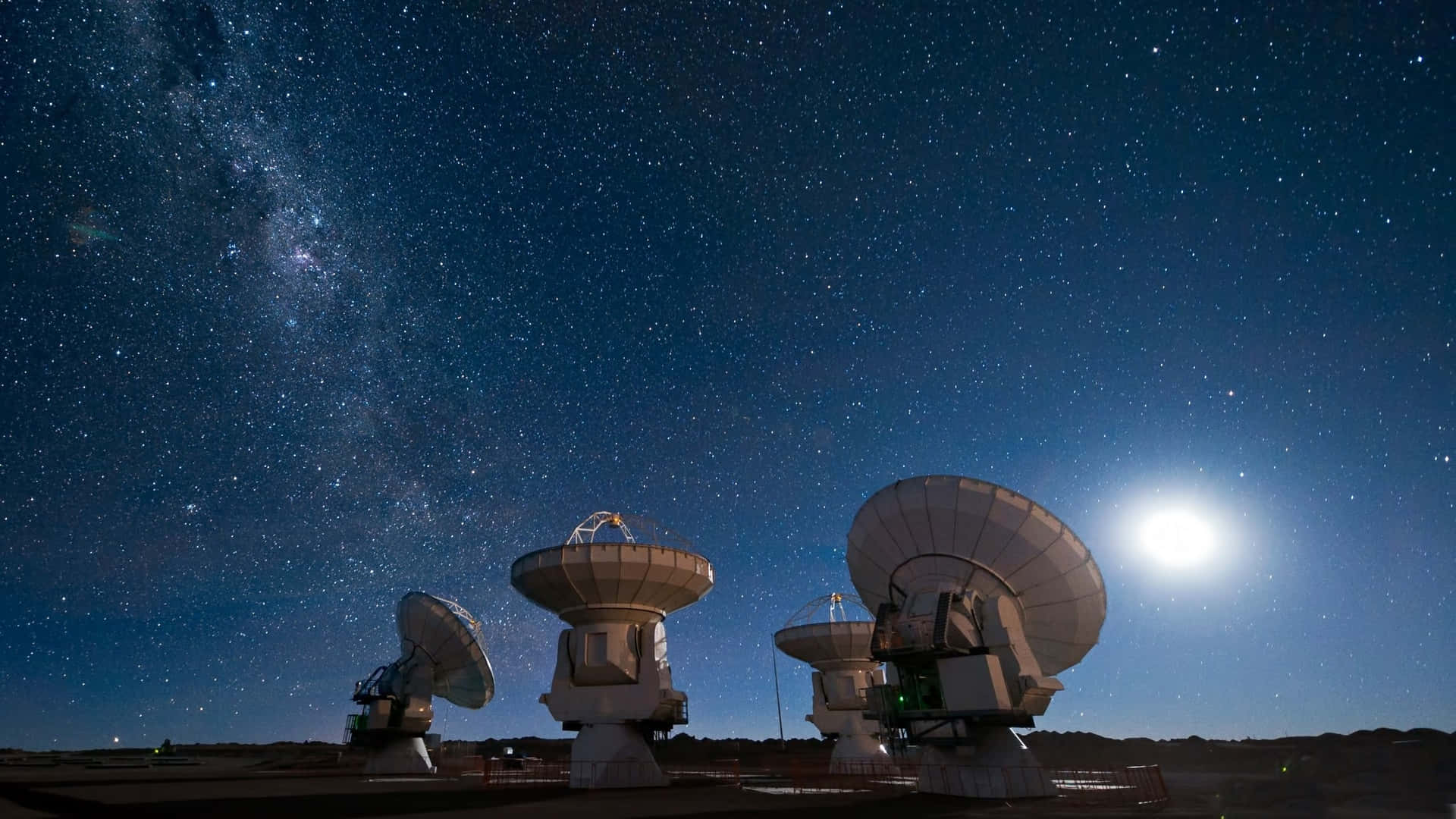 a group of radio telescopes under the night sky