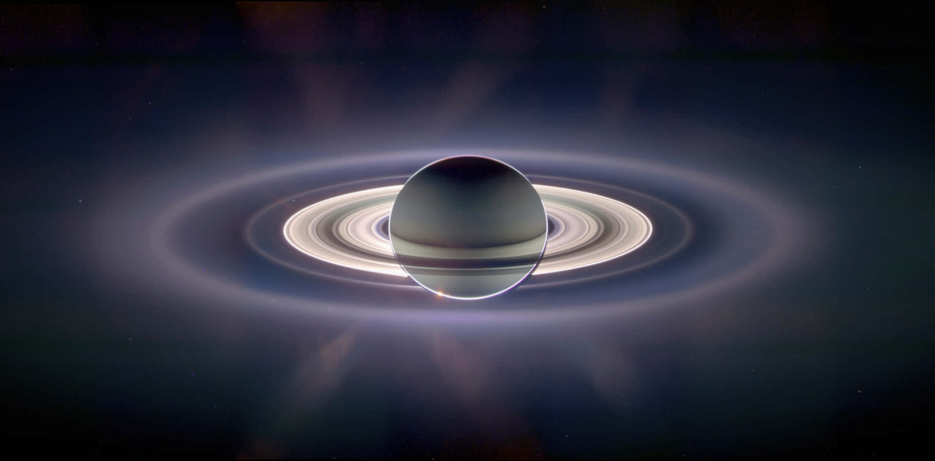 Saturn's Rings And Moons In A Dark Background