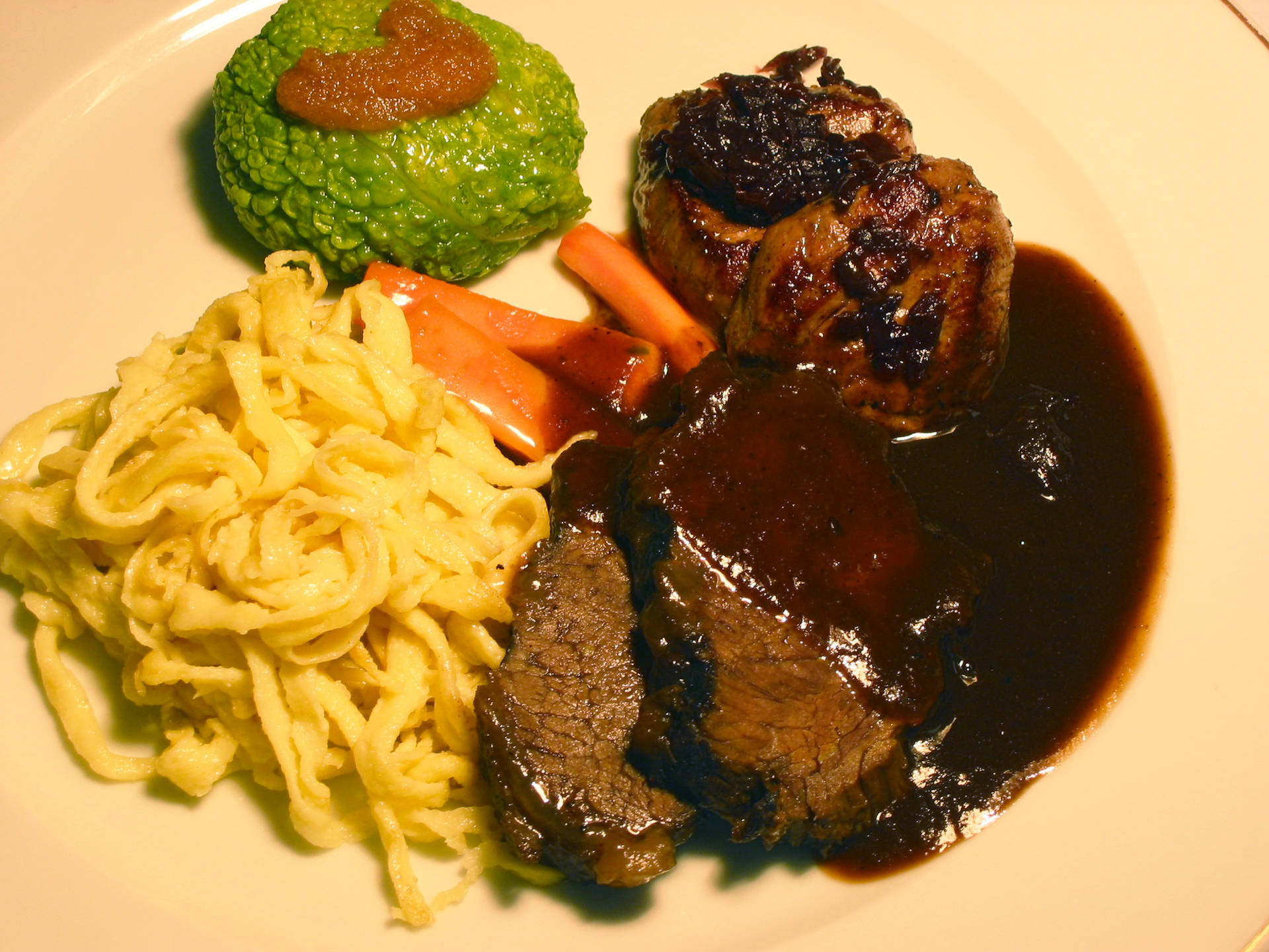 Traditional Sauerbraten Dish Served with Pasta and Mashed Vegetables Wallpaper