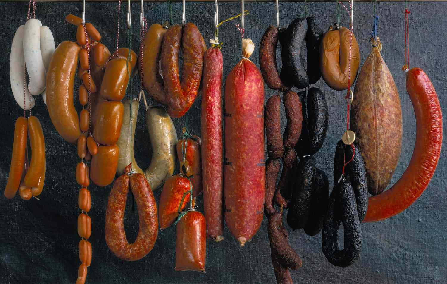 A Variety Of Sausages Hanging On A String