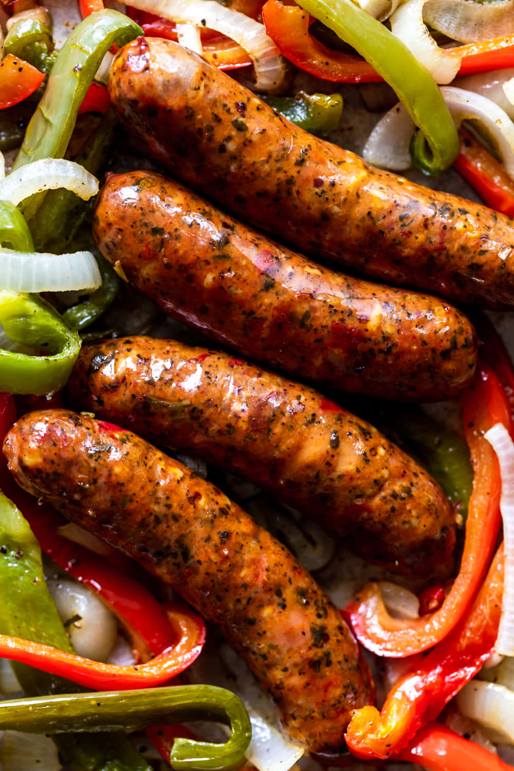 A Plate With Sausages And Peppers