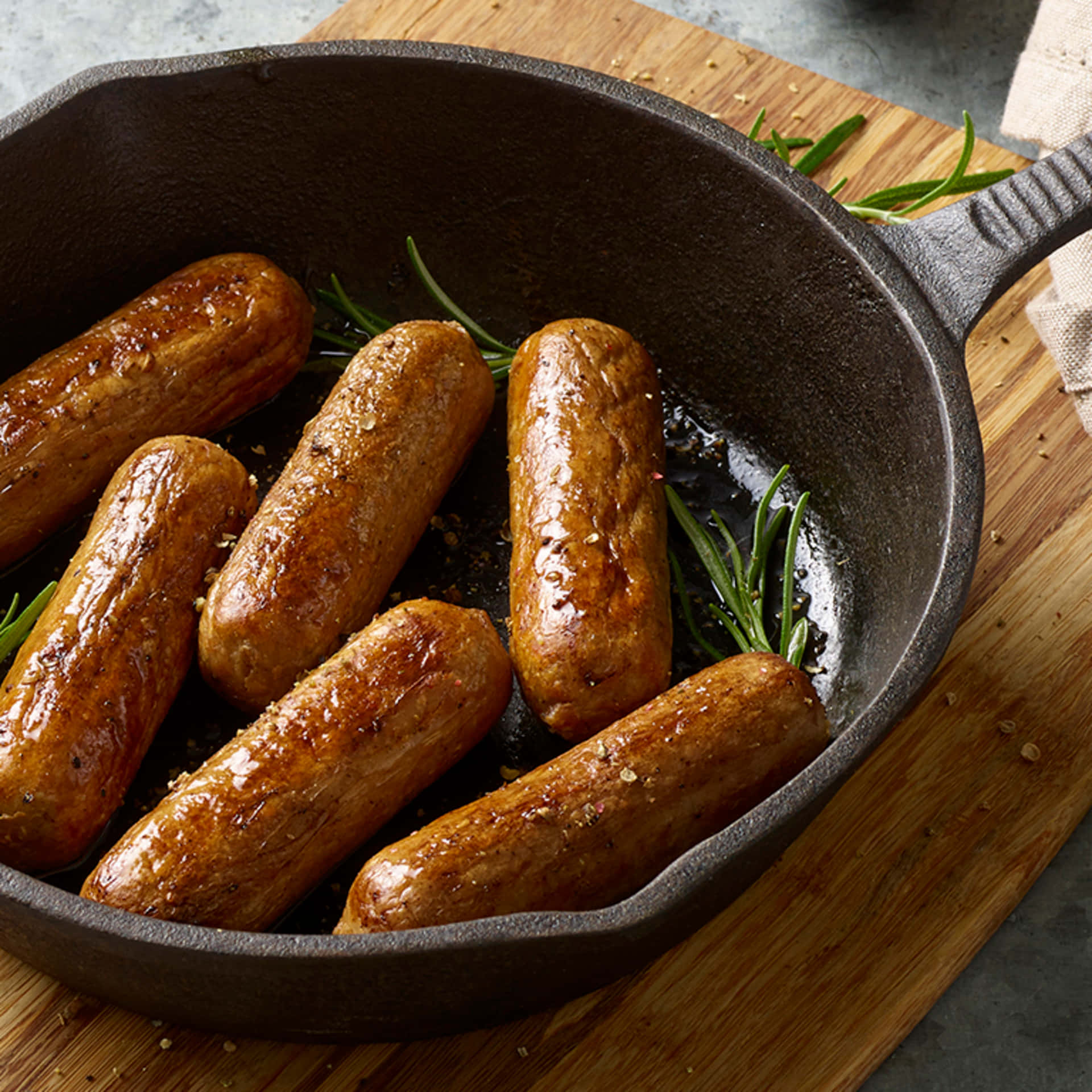 A Cast Iron Skillet With Sausages In It