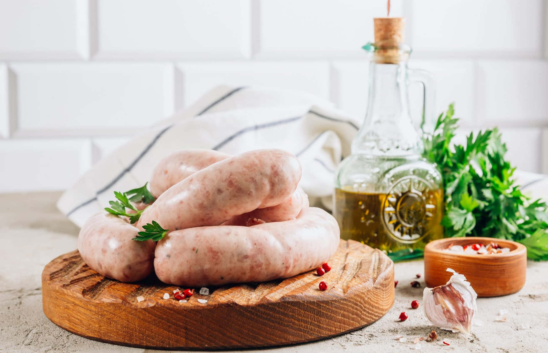 Sausages On A Wooden Cutting Board With Herbs And Garlic