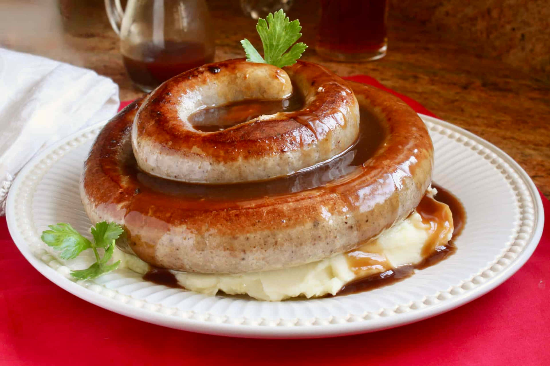 A Plate With A Sausage And Gravy On It