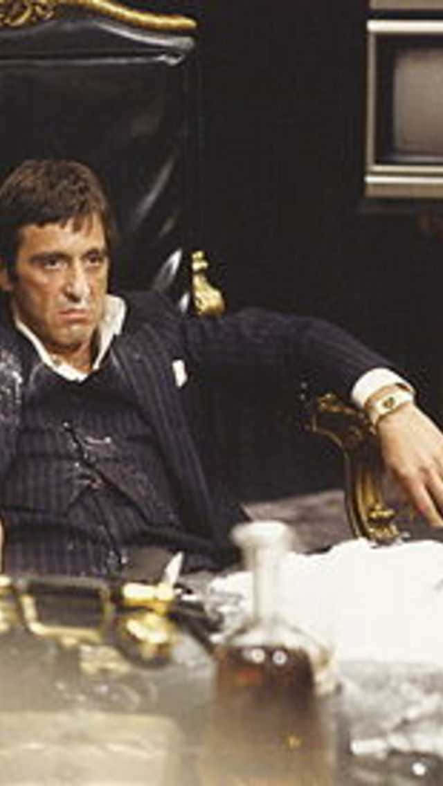 The iconic Tony Montana in Scarface posed with his gun in an intense scene