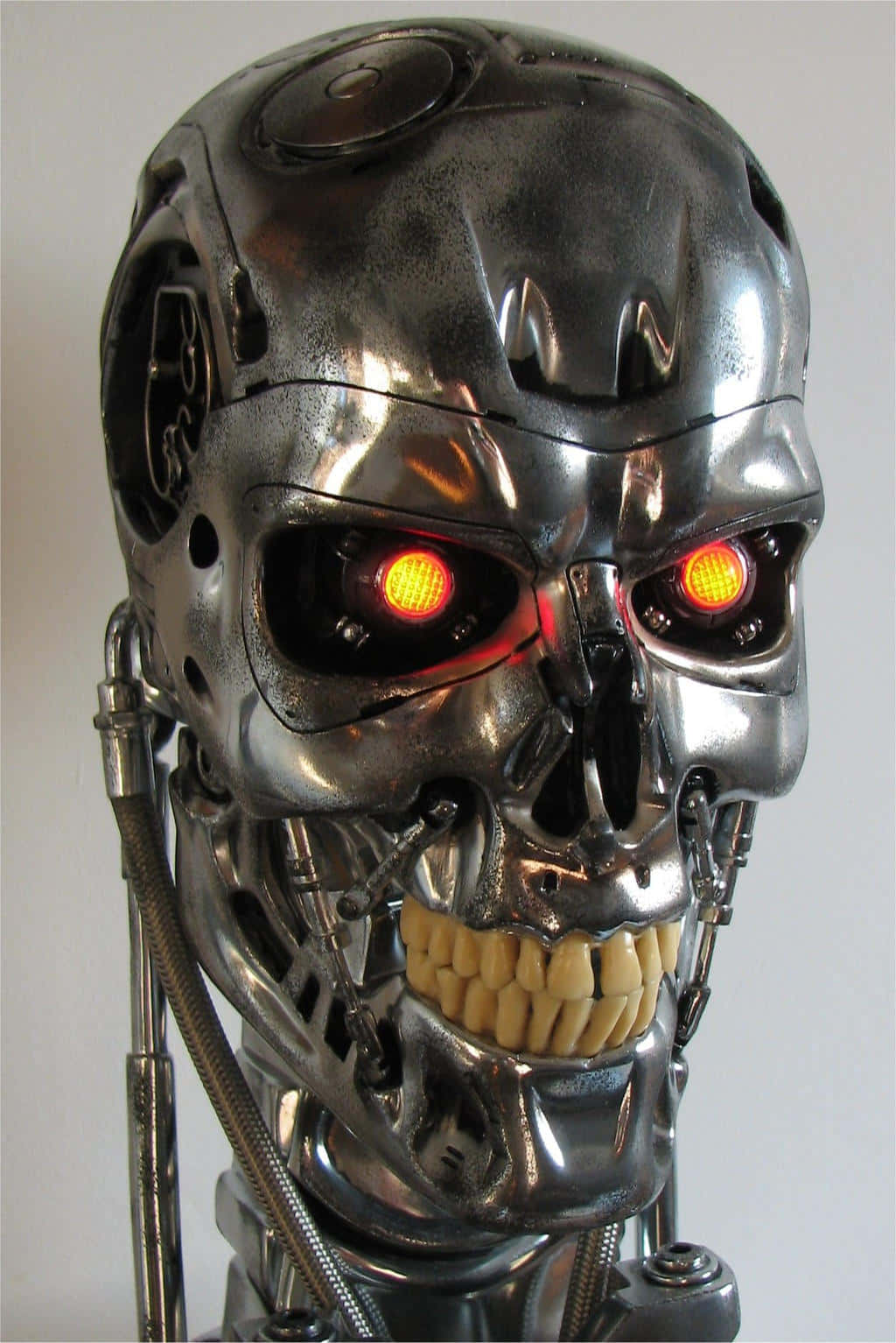 a robot with red eyes and a skull