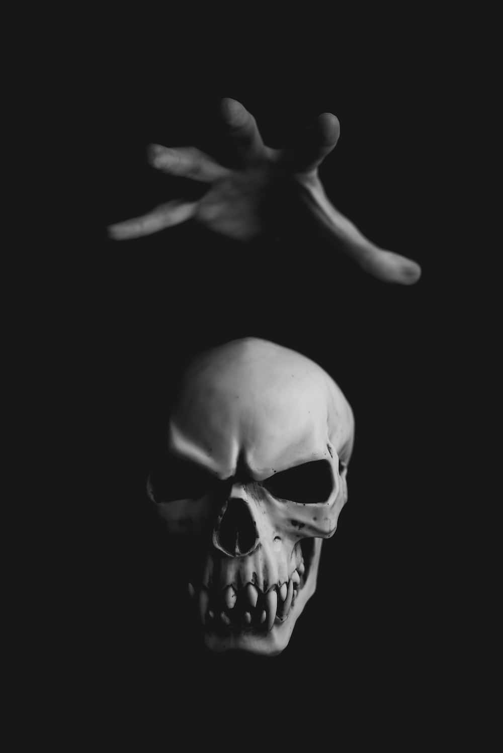 a skull with a hand reaching out