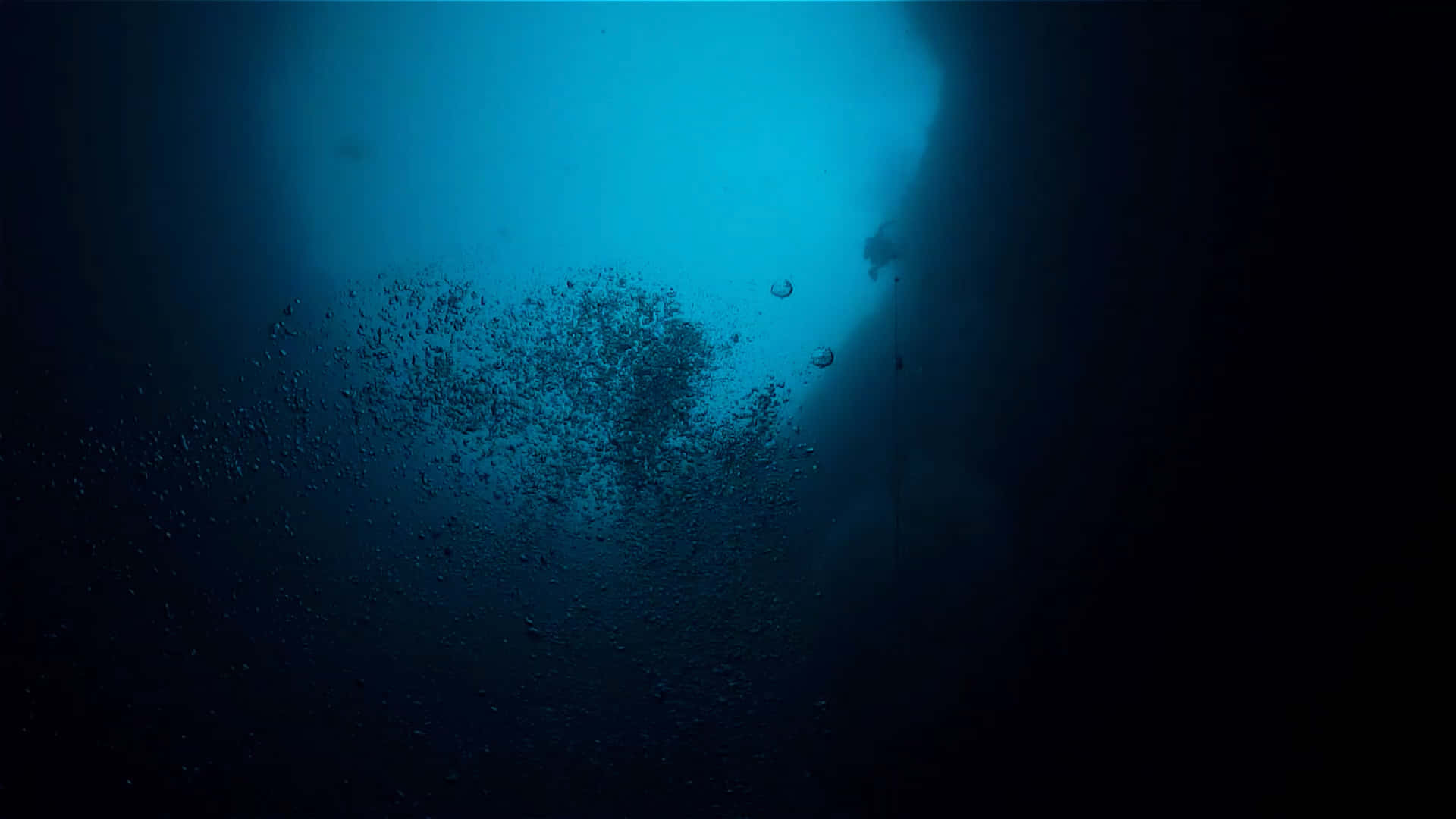 An eerie underwater scene of a deep sea abyss.