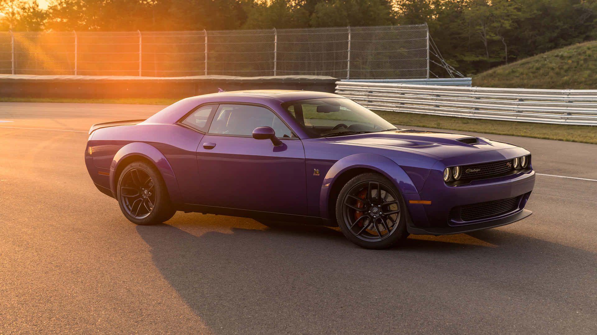 The 2020 Dodge Challenger Is Driving Down A Track Wallpaper