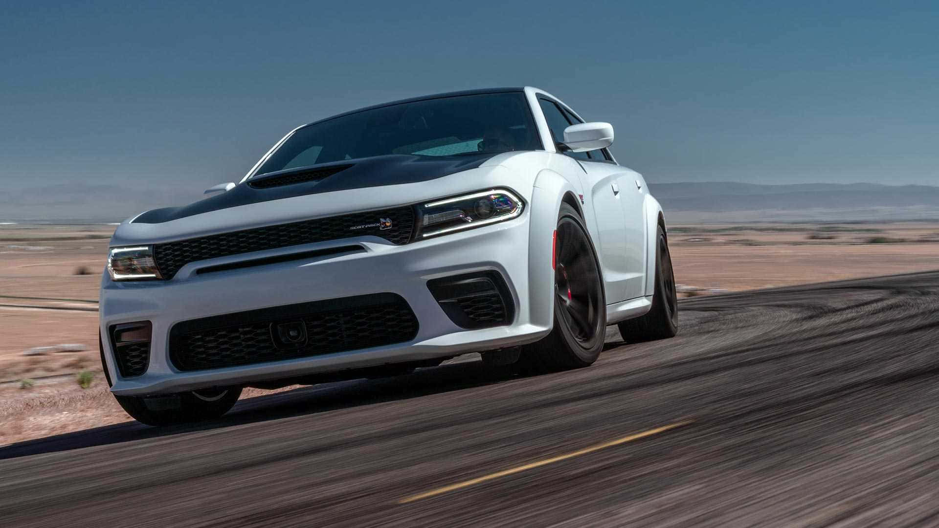 The 2020 Dodge Charger Srt Is Driving On A Desert Road Wallpaper